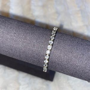 CZ tennis bracelet with triple closure.